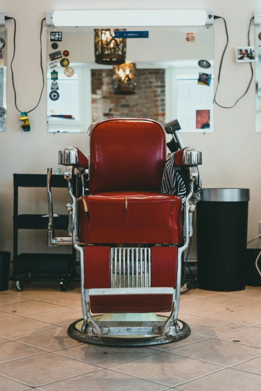 a barber chair is on the floor, in front of some pictures