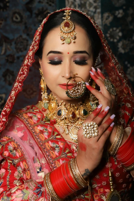a woman wearing gold jewelry in red and gold