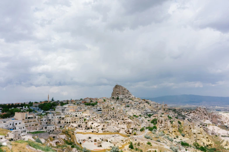 clouds gather in the sky above a small village