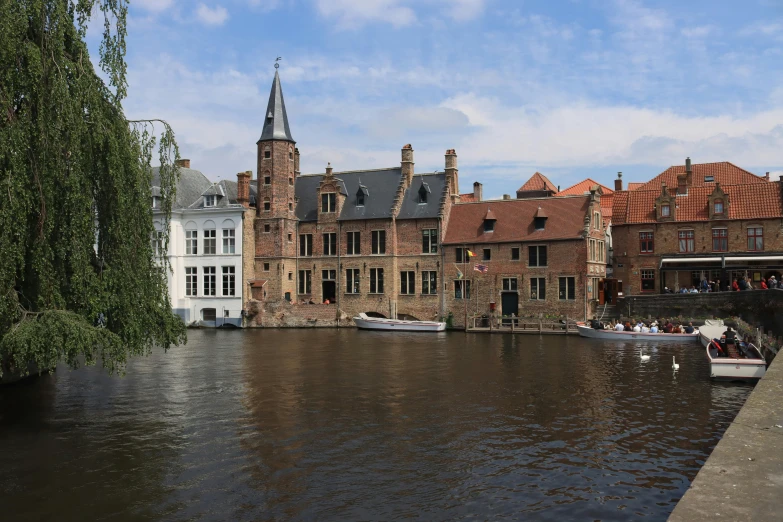boats are docked in the water outside a brick building
