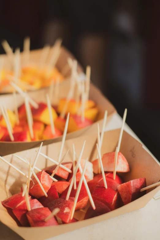 two boxes filled with fruit sitting on a table