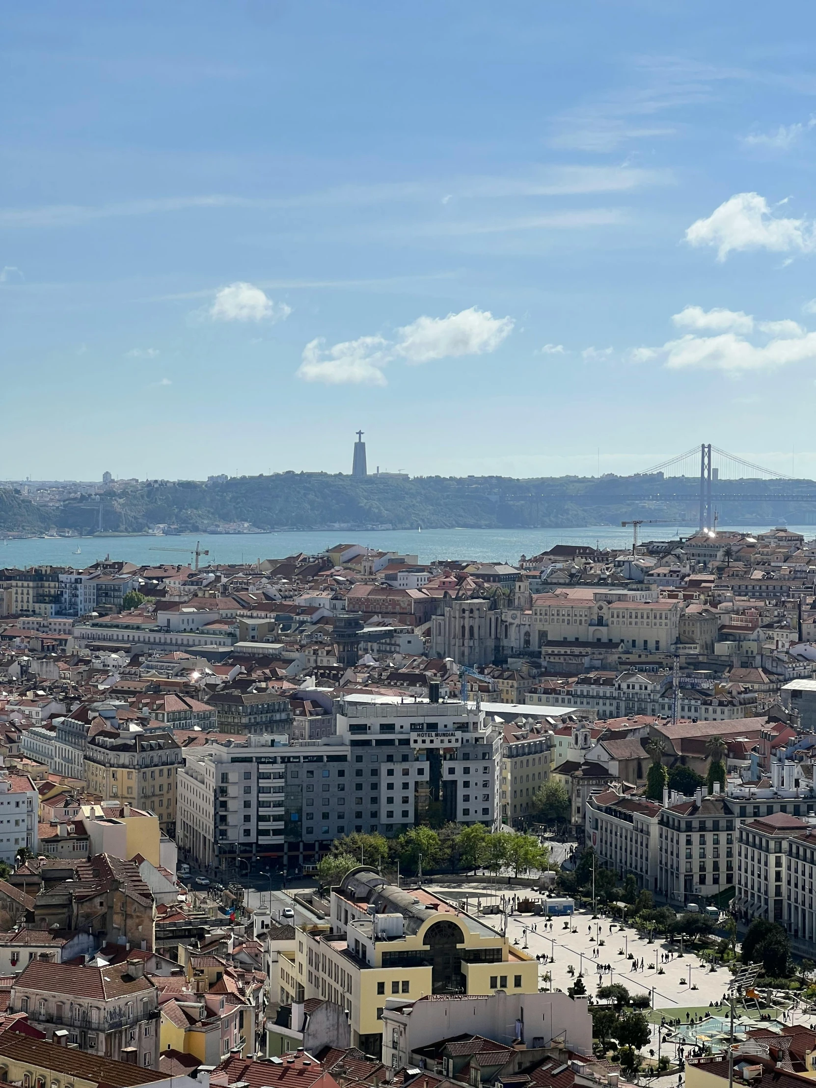 view of some old houses and buildings with a very tall clock tower in the background