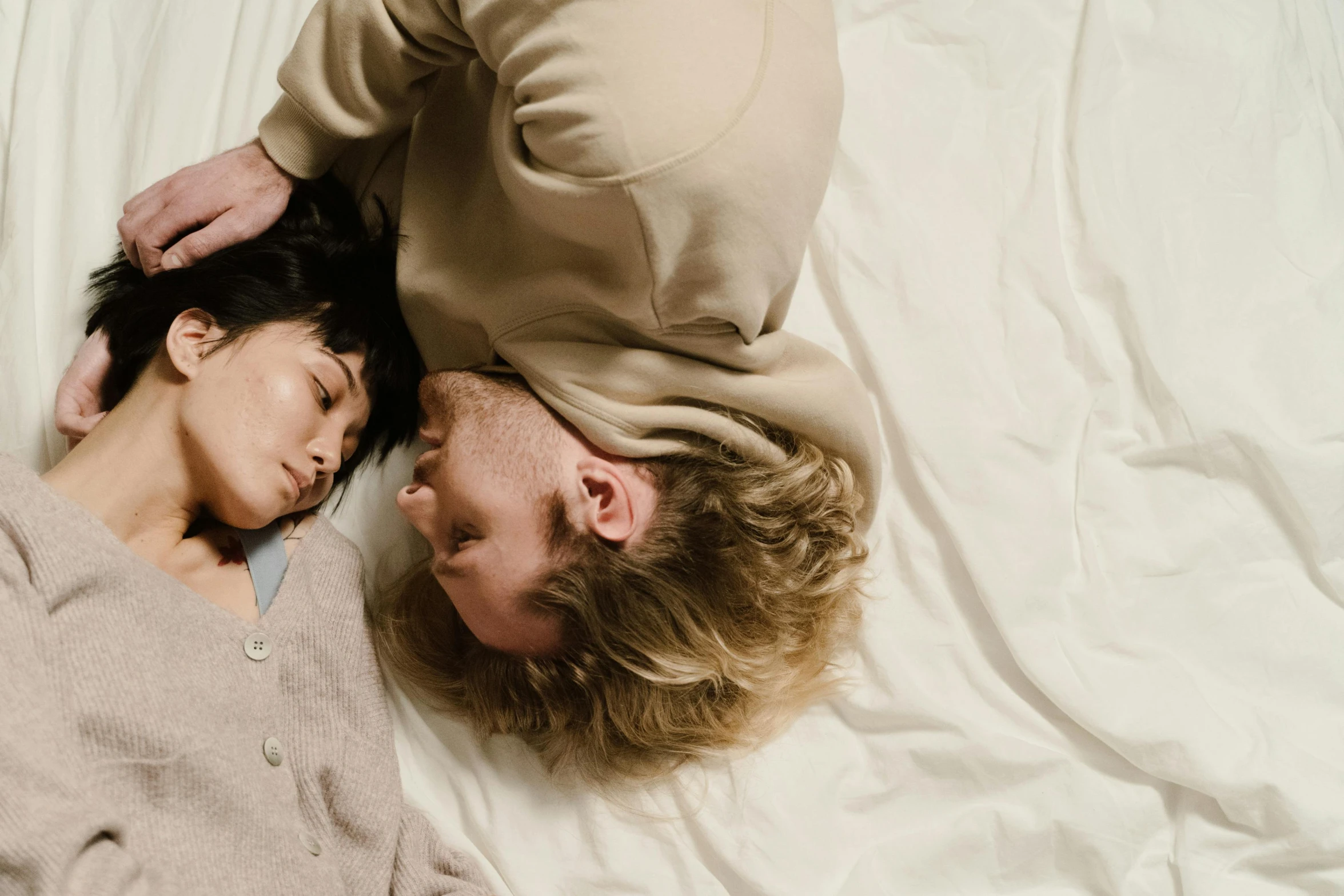 a man and a woman laying in the bed