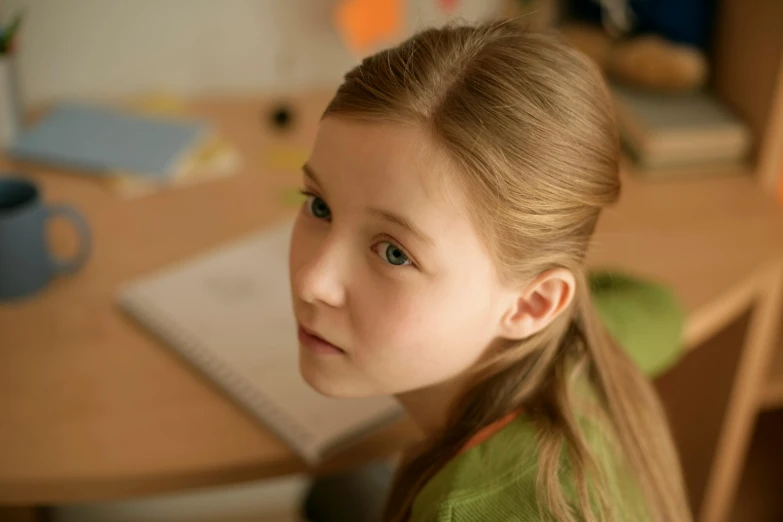 a  in a green blouse looking off into the distance