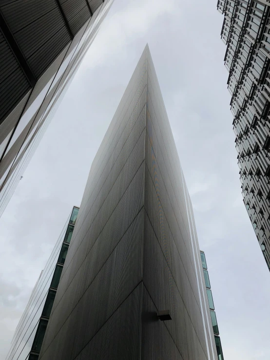 a tall building sitting under the cloudy sky