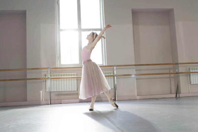 a girl in a ballet costume performing a ballet routine