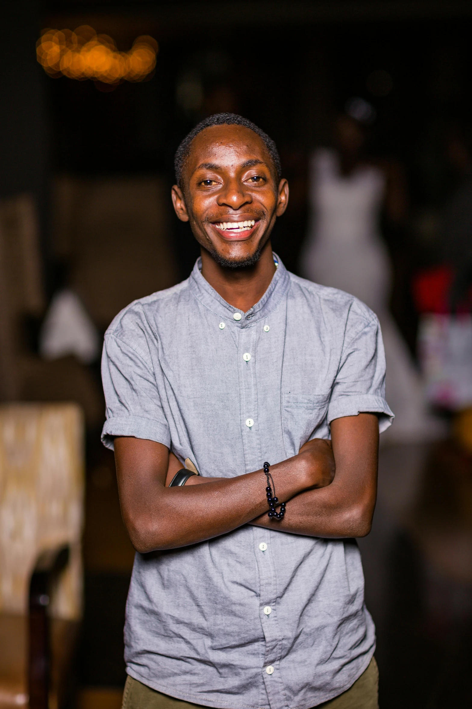 a man is smiling and standing outside