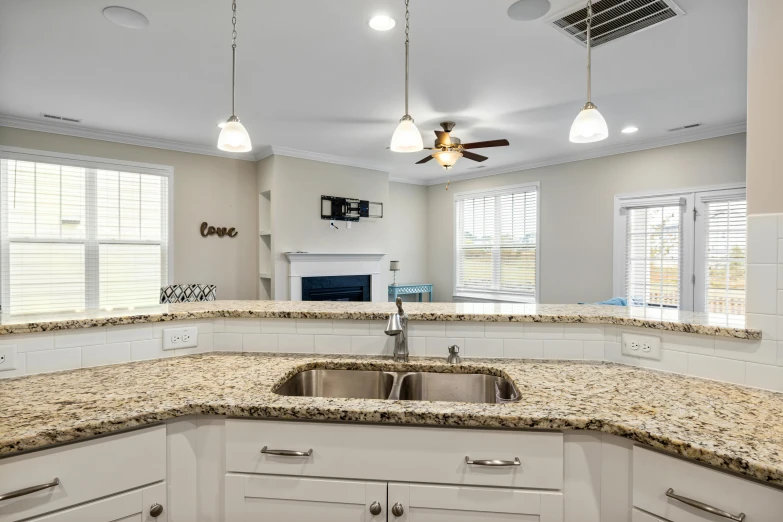 the kitchen has granite countertops and white cabinets