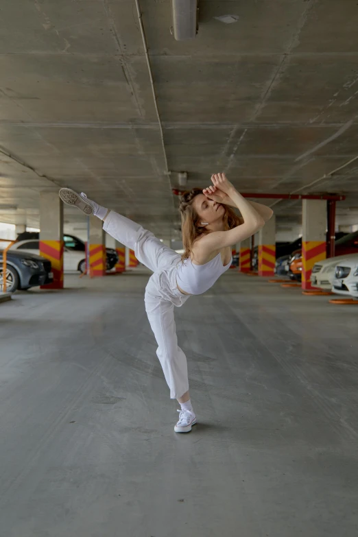 a woman standing in a parking garage doing yoga