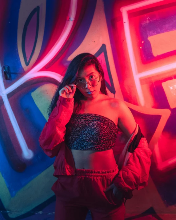 a woman standing in front of graffiti on the wall