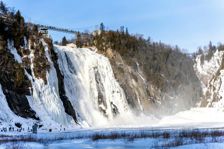 a mountain side with some water and snow