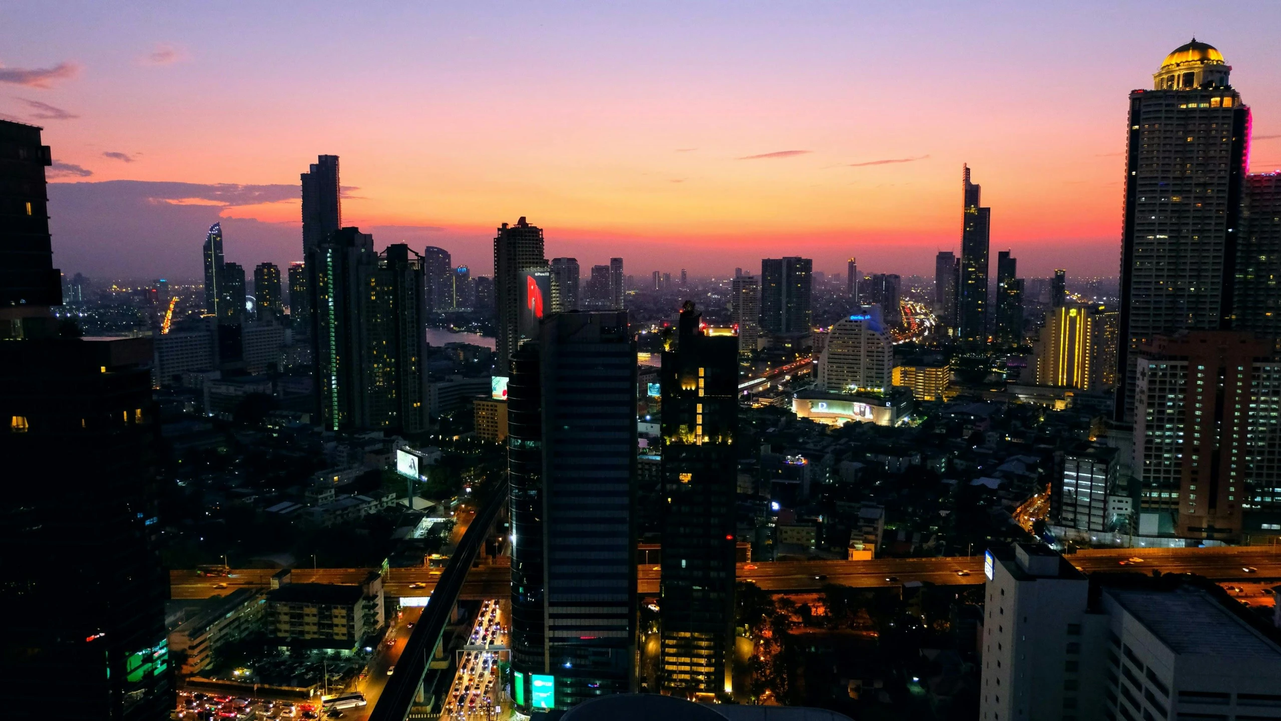 view of city skyline at dusk from a tall building