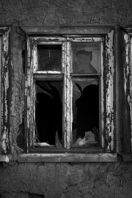 black and white pograph of broken windows with the shadows cast