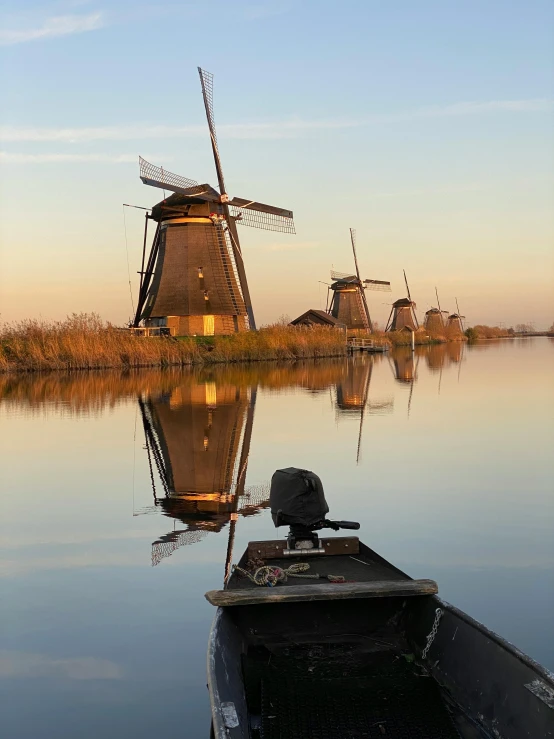 the water with the boat near it is calm and beautiful