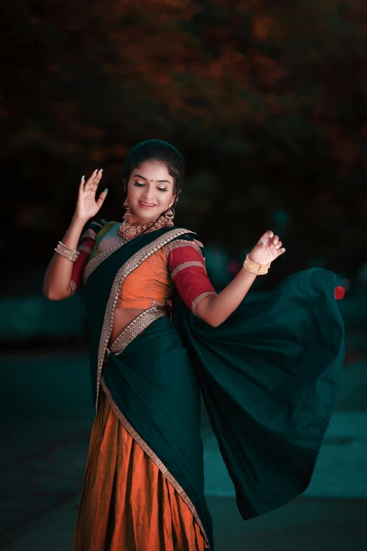 indian woman in traditional clothes posing for a pograph