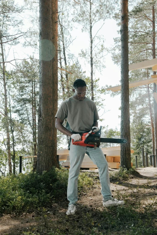 a man with a chainsaw in the forest