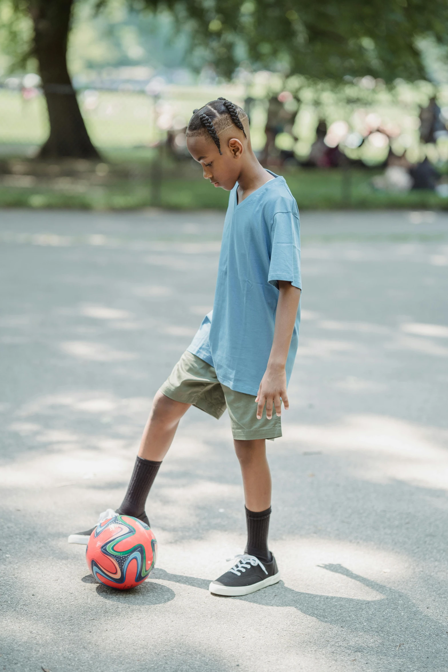 a  playing with a ball on the ground