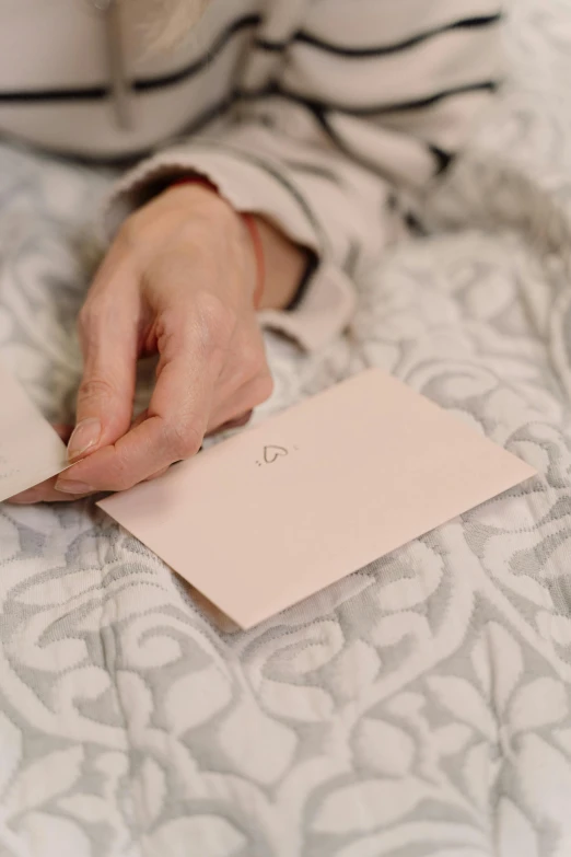 a women holding her hand on top of an empty notepad