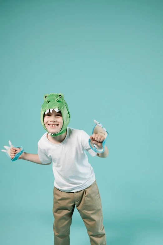 a child in a frog costume holding scissors