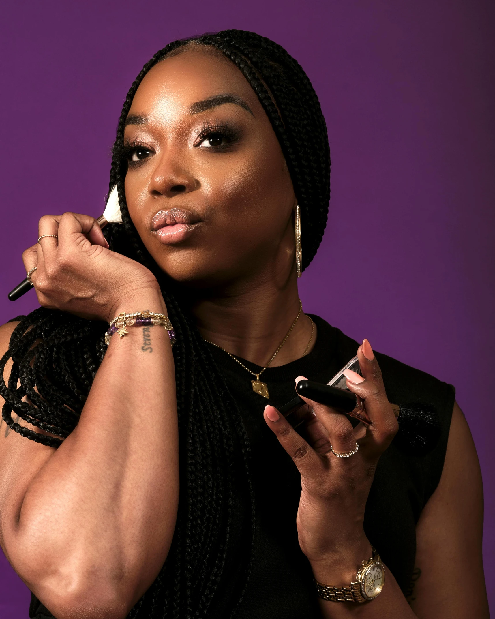 an african american woman holding her hand near her face