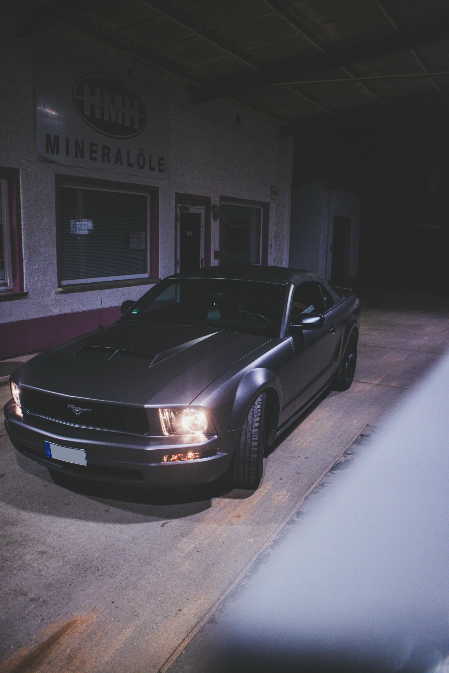 a car parked on a curb in front of a building