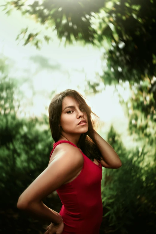 a woman in a red dress posing for a po