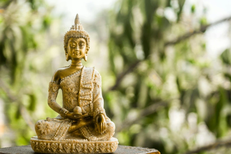 a statue is sitting on top of a wooden platform