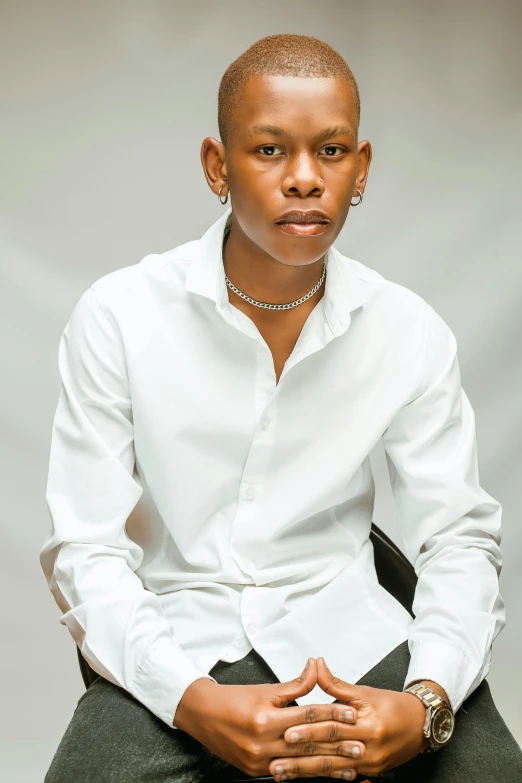 an african american woman in white shirt sitting down