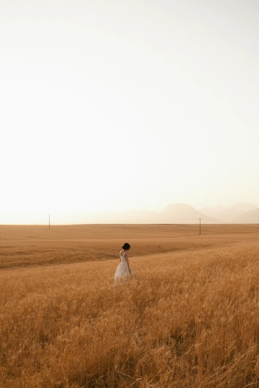 a woman in the middle of a large field