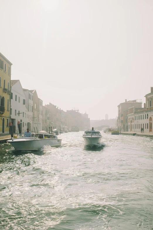 boats floating down the middle of a river