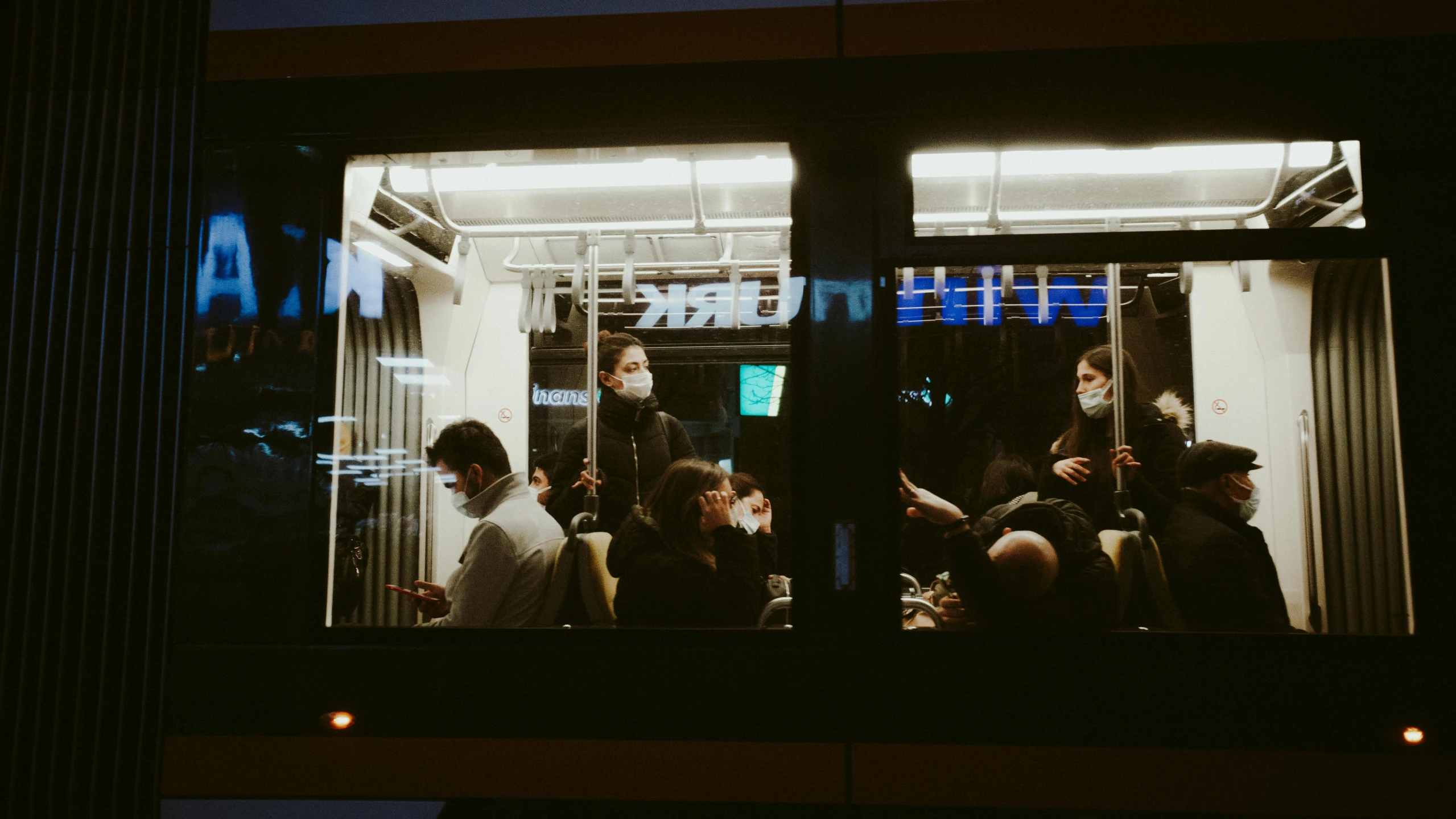 a group of people on the bus at night