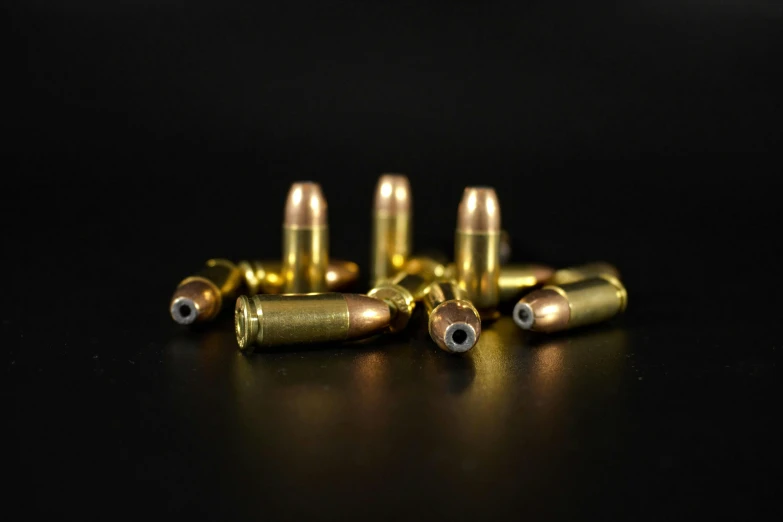 several ss bullet ss lay on a black surface