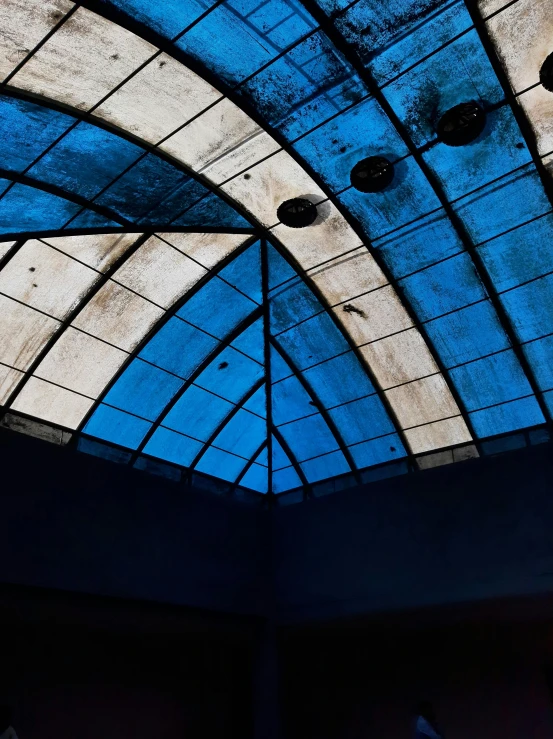 a blue ceiling in the shape of an abstract structure