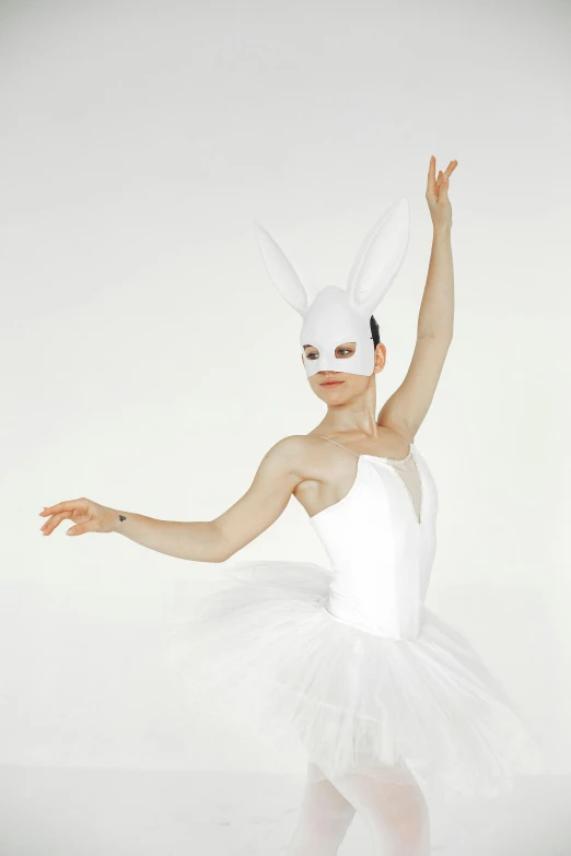 a woman standing on one leg wearing a rabbit mask