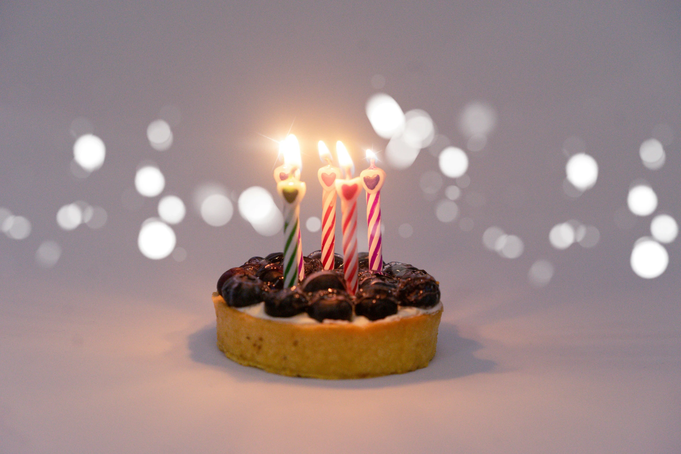 a cake with three candles on it with some candles in the center