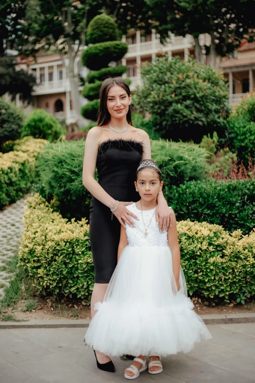 two s in formal dresses are posing for a po