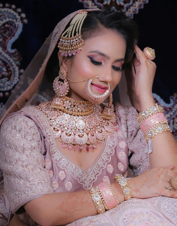 a young indian woman in a wedding outfit looking down