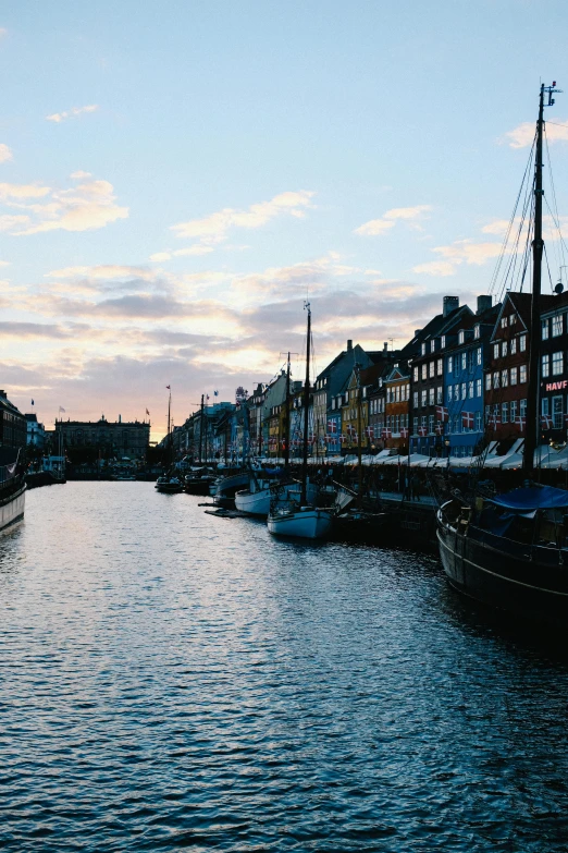 a canal with small boats on both sides