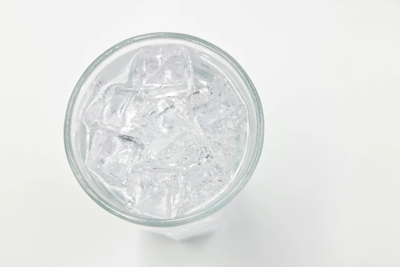 an empty glass with ice on top of it