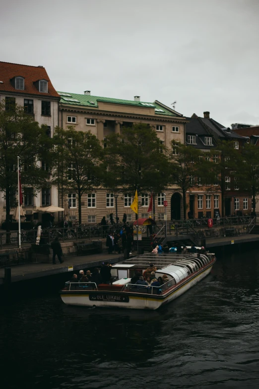 a boat on water next to some buildings