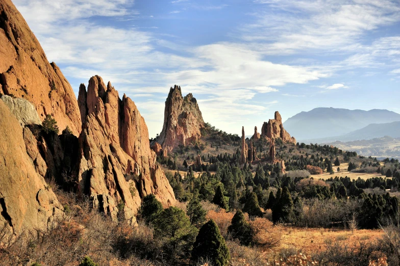 the rock formations are in the foreground, and mountains in the background