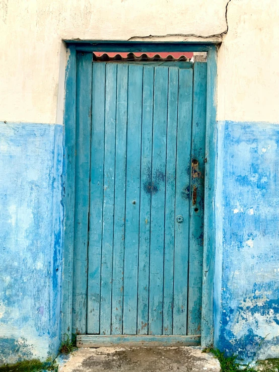 a closed wooden door of an old building