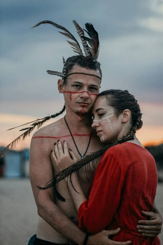 a couple is dressed in native clothing posing for the camera