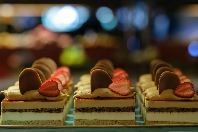 several desserts with strawberries sitting in a row