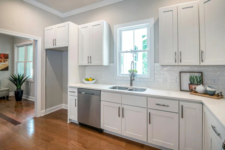 a white kitchen with a large open window