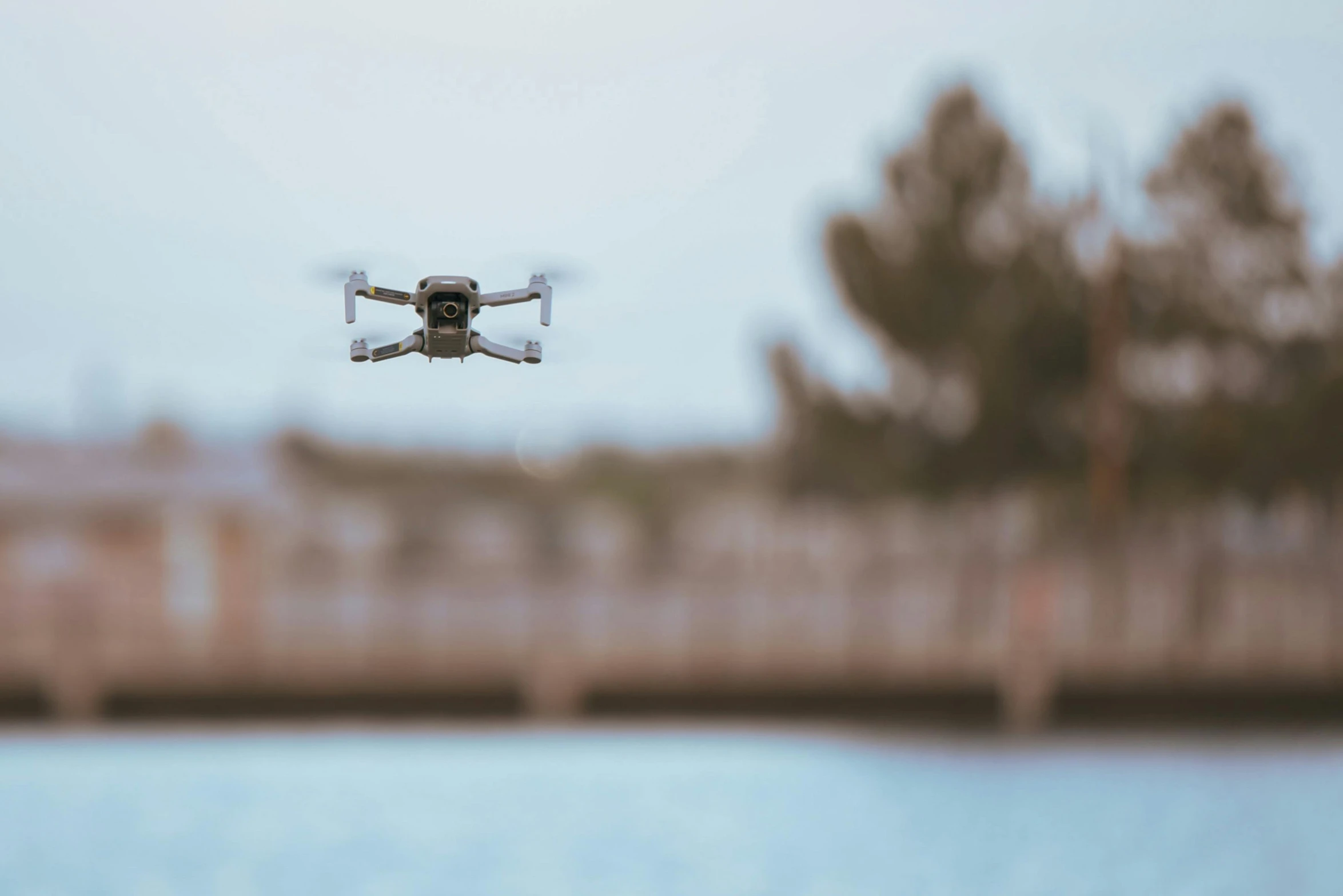 a small flying device hovering over a body of water