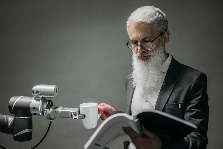 a person reading a book while holding a camera