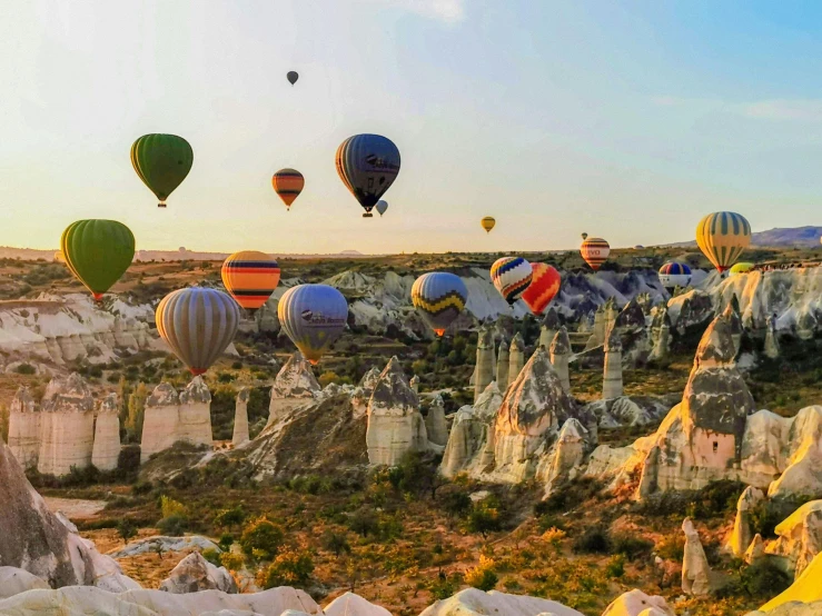 colorful  air balloons flying above the rocky landscape