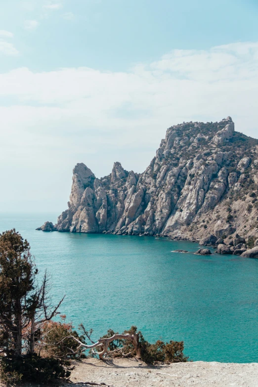 a very large body of water near a big rocky outcropping