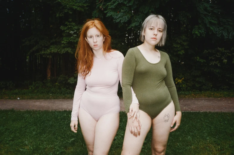 two women standing next to each other in their underwear